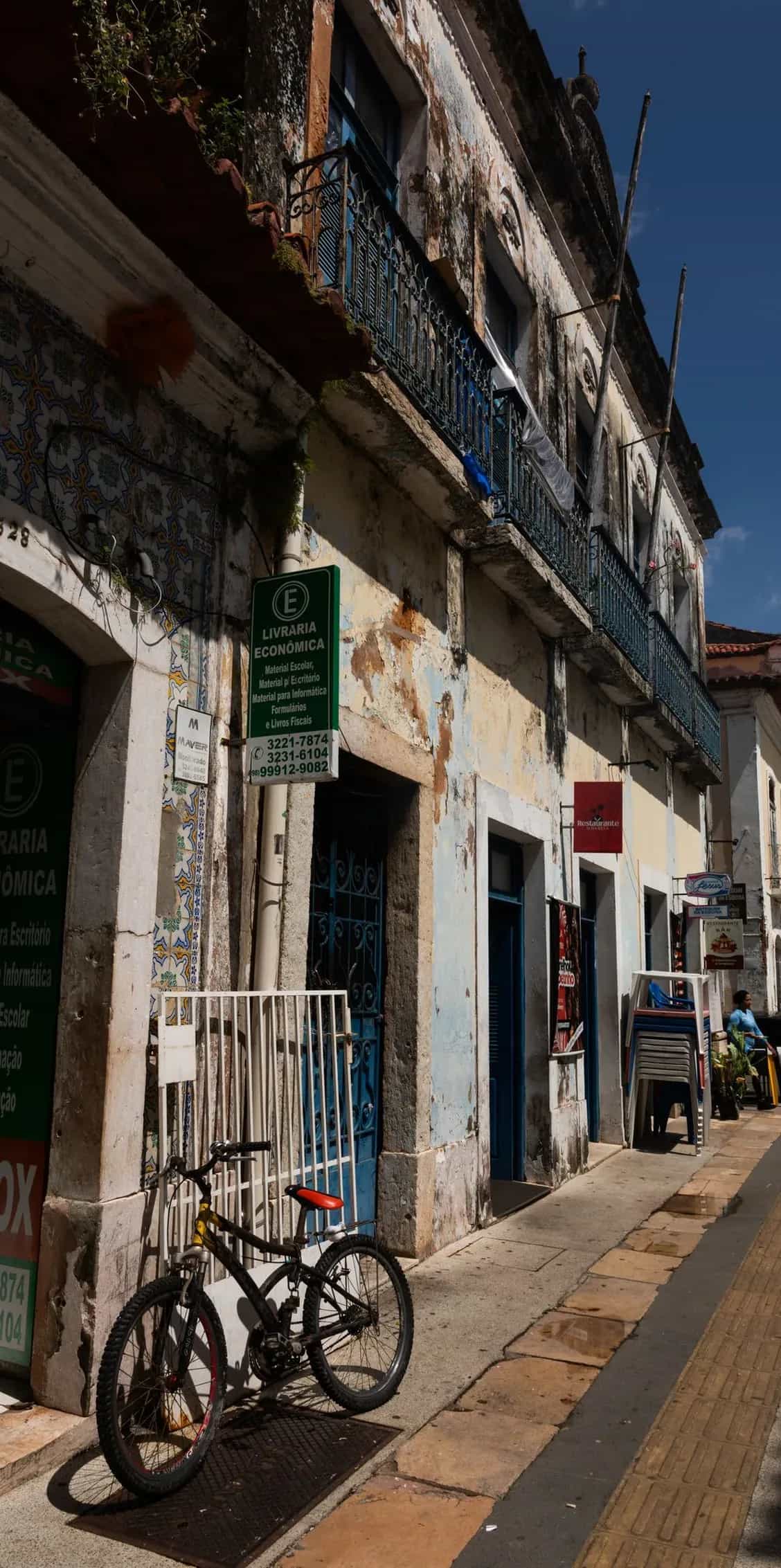 Rua do centro histórico de São Luís com lojas e livraria